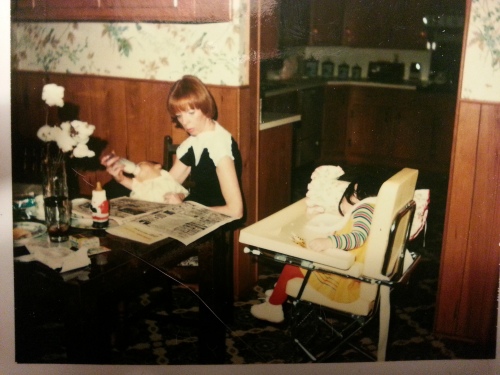 This picture says it all.  My Mom feeding two children and reading the newspaper.  I'm in the highchair.